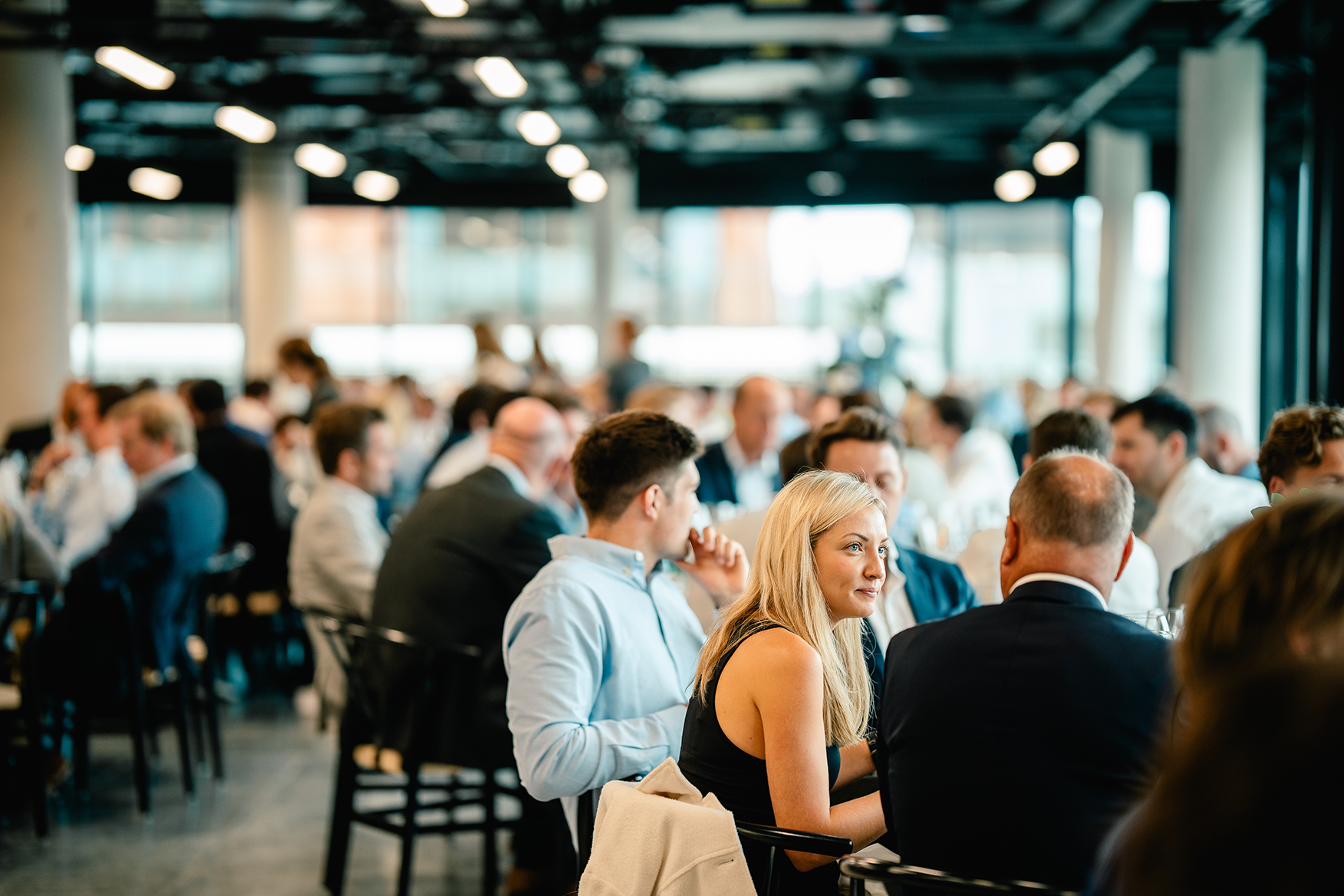 people enjoying dinner in new office building launch